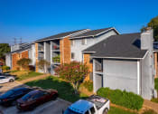 Thumbnail 50 of 55 - an apartment building with cars parked in front of it at Water Ridge Apartments, Texas