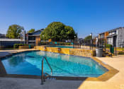 Thumbnail 49 of 55 - a swimming pool with a reflection of a building and a fountain at Water Ridge Apartments, Irving, 75061