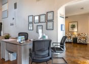 Thumbnail 55 of 55 - an office with a desk and chairs in front of a wall with photos on it at Water Ridge Apartments, Irving, TX