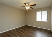 Thumbnail 13 of 55 - an empty room with a ceiling fan and wood floors at Water Ridge Apartments, Irving, 75061