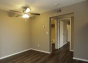 Thumbnail 15 of 55 - an empty living room with a ceiling fan at Water Ridge Apartments, Irving