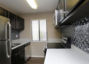 Thumbnail 17 of 55 - a kitchen with a stove and a window at Water Ridge Apartments, Texas