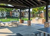 Thumbnail 15 of 42 - A park with tables and benches under a roof at Water Ridge Apartments , Texas