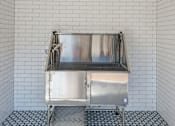 Thumbnail 18 of 42 - A stainless steel sink in a tiled bathroom at Water Ridge Apartments , Texas, 75061