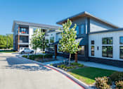Thumbnail 51 of 52 - A modern two-story building with a white car parked in front at The Virginia Apartments , Seguin, 78155