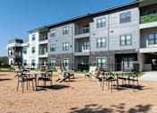 Thumbnail 16 of 52 - A sunny day at the outdoor seating area of a modern apartment complex at The Virginia Apartments , Texas, 78155
