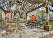 Thumbnail 35 of 42 - A picnic table is under a wooden pergola.