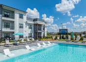 Thumbnail 2 of 52 - A swimming pool in front of apartment buildings at The Virginia Apartments , Texas, 78155