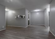 Thumbnail 3 of 42 - A room with a grey wall and a wooden floor.