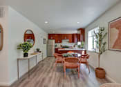 Thumbnail 5 of 23 - A modern kitchen with wooden floors and furniture.
