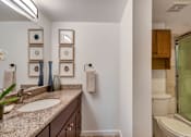 Thumbnail 17 of 39 - A bathroom with a sink, toilet, and a glass shower door.