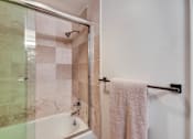 Thumbnail 18 of 39 - A white towel hangs on a towel bar in a bathroom.