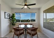 Thumbnail 7 of 39 - A dining room with a table and chairs and a ceiling fan.