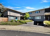 Thumbnail 39 of 39 - A row of modern townhouses with a clear blue sky above.