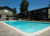 Thumbnail 26 of 27 - A swimming pool in front of a building.