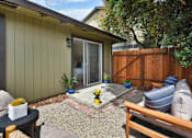 Thumbnail 22 of 27 - A patio area with a table, chairs, and a bench.