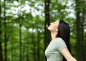 Thumbnail 1 of 9 - A woman with long black hair is standing in a forest.