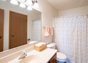 Thumbnail 18 of 18 - A bathroom with a white sink and a white toilet. Fargo, ND Cedars 4 Apartments