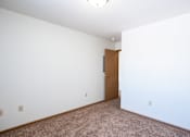 Thumbnail 37 of 44 - A room with a brown carpet and a brown door.