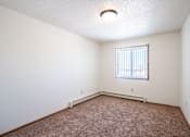 Thumbnail 40 of 44 - A room with a window and a carpeted floor.