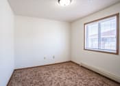 Thumbnail 38 of 44 - A room with a window and carpeted floor.