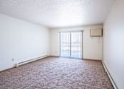 Thumbnail 31 of 44 - A room with a carpeted floor and a window with blinds.