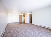 Thumbnail 32 of 44 - A room with a carpeted floor and a white wall.