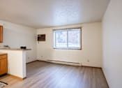 Thumbnail 9 of 13 - A room with a window and a wooden floor. Fargo, ND Candlelight Apartments