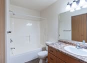 Thumbnail 30 of 44 - A white bathroom with a toilet, sink, and bathtub. Fargo, ND Country Edge Apartments