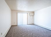 Thumbnail 18 of 44 - A room with a carpeted floor and a window with blinds. Fargo, ND Country Edge Apartments