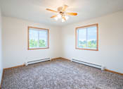 Thumbnail 9 of 23 - A room with a ceiling fan and two windows. Fargo, ND Summit Point Apartments