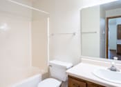 Thumbnail 23 of 23 - A white toilet sits next to a white sink in a bathroom. Fargo, ND Somerset Apartments