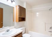Thumbnail 22 of 23 - A white bathroom with a sink, toilet and bathtub. Fargo, ND Somerset Apartments