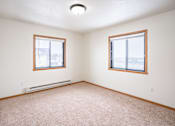 Thumbnail 18 of 23 - A room with two windows and a carpeted floor. Fargo, ND Somerset Apartments