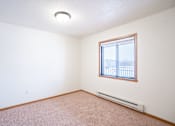 Thumbnail 21 of 23 - A room with a window and a heater on the floor. Fargo, ND Somerset Apartments