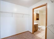 Thumbnail 20 of 23 - A white wall with a towel rack and a bathroom in the background. Fargo, ND Somerset Apartments