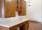 Thumbnail 17 of 23 - A desk with wooden cabinets and a white countertop. Fargo, ND Somerset Apartments