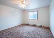 Thumbnail 17 of 23 - A room with a ceiling fan and a window. Fargo, ND Summit Point Apartments