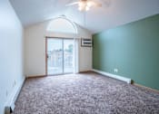 Thumbnail 13 of 23 - A room with a carpeted floor and a ceiling fan. Fargo, ND Summit Point Apartments