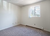 Thumbnail 17 of 21 - A room with a window and a radiator on the floor. Bismarck, ND Belmont Apartments