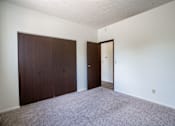 Thumbnail 18 of 21 - A room with a carpeted floor and two doors. Bismarck, ND Belmont Apartments