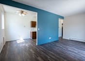 Thumbnail 13 of 21 - A room with a ceiling fan and a wooden cabinet. Bismarck, ND Belmont Apartments
