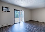 Thumbnail 12 of 21 - A room with a sliding glass door leading to a patio. Bismarck, ND Belmont Apartments