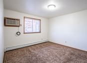 Thumbnail 12 of 16 - A room with a window and a carpet on the floor. Fargo, ND Birchwood 2 Apartments