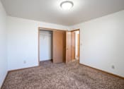 Thumbnail 13 of 16 - A room with a carpeted floor and a ceiling light. Fargo, ND Birchwood 2 Apartments