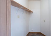 Thumbnail 19 of 21 - A white wall with a brown shelf and hooks. Dilworth, MN Fieldstone Apartments