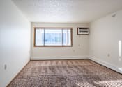 Thumbnail 15 of 21 - A room with a window and a carpet on the floor. Dilworth, MN Fieldstone Apartments