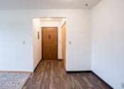 Thumbnail 18 of 20 - A room with a wooden door and floor. West Fargo, ND Saddlebrook Apartments