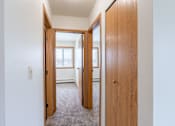 Thumbnail 17 of 20 - A hallway with two doors on either side leading to other rooms. West Fargo, ND Saddlebrook Apartments