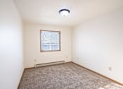 Thumbnail 10 of 17 - A room with a window and carpeted floor. Fargo, ND Fieldstone Apartments